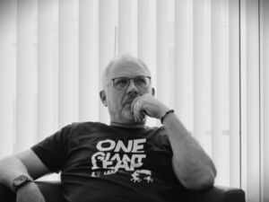 Oliver Welte, co-founder of Leapter, seated and deep in thought, wearing a ‘One Giant Leap’ t-shirt.